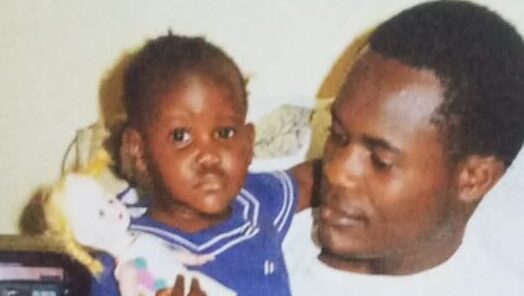 This image shows Walter Ooko holding his baby daughter, Beryl, in 1995. It gives more emotional impact to the story.
