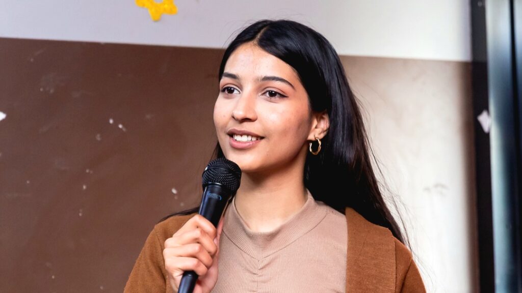 Prasidika Dhungana speaks into a microphone at one of her recent Students For Liberty events.