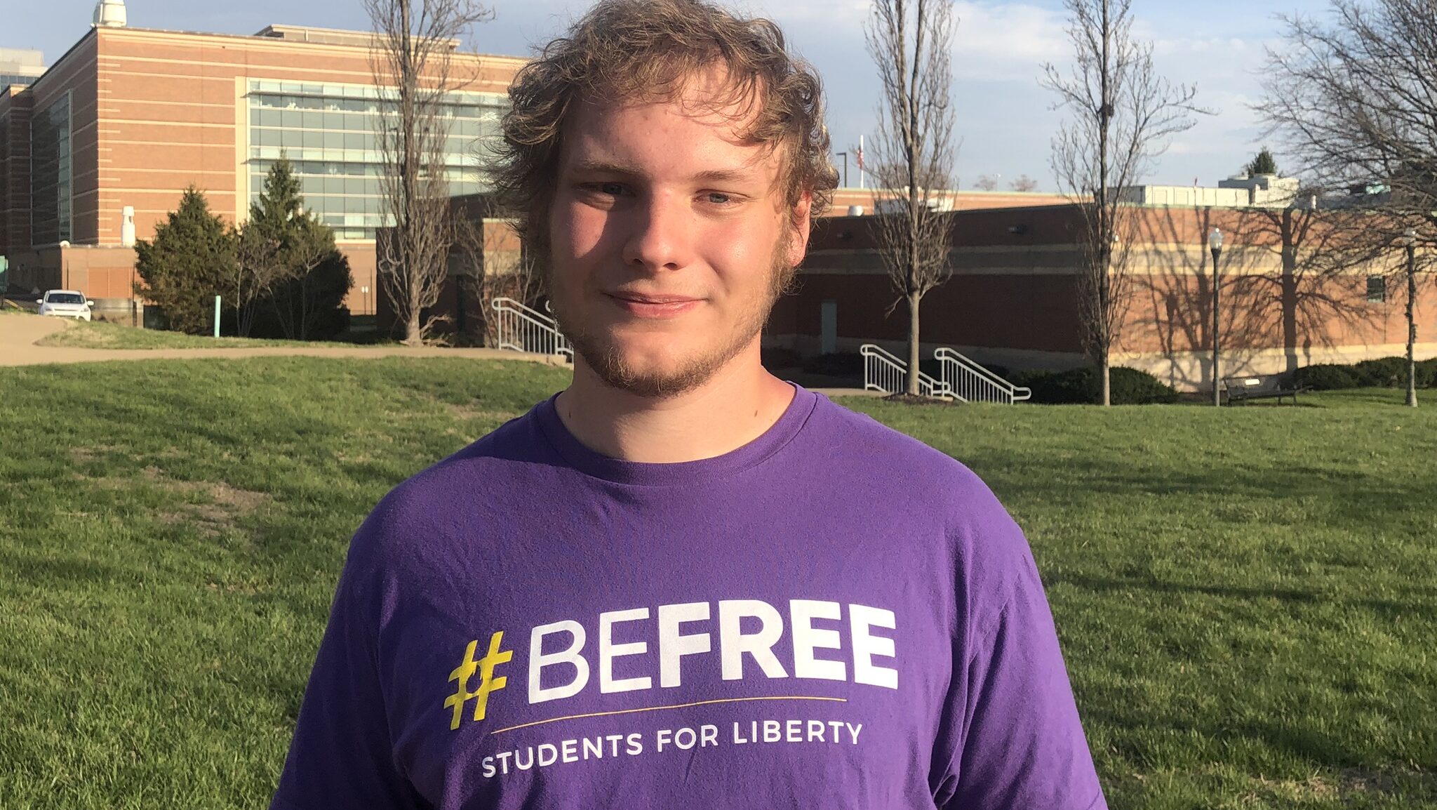 Students For Liberty's Evan Kemp stands while tabling at a Missouri university.